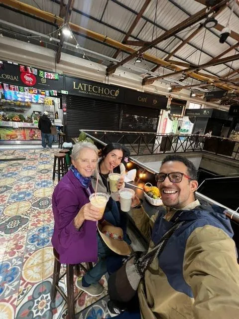 Trying fresh fruit juices at a local market